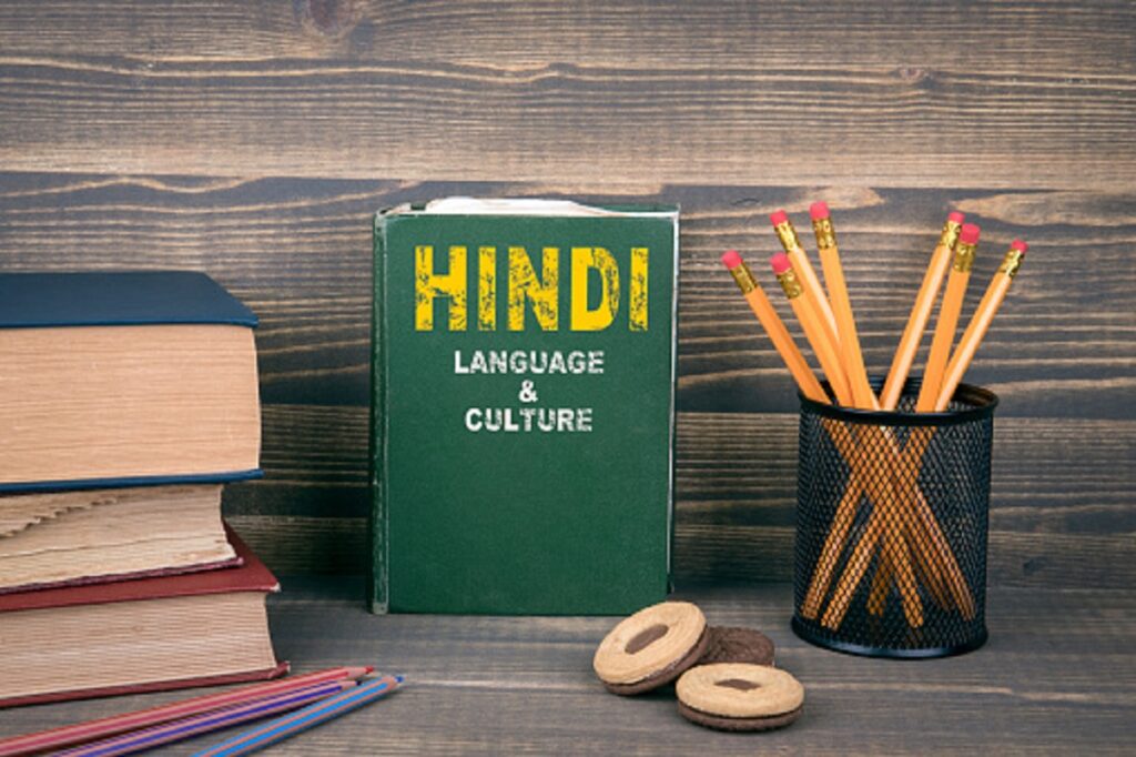 Hindi language and culture concept. Book on a wooden background